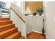 Wooden staircase showcasing hardwood steps and railing, and natural light at 200 Cocoanut Ave # 1, Sarasota, FL 34236