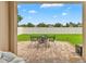 Inviting back patio with a table and chairs, perfect for outdoor entertaining and relaxing at 2118 Song Sparrow Ct, Ruskin, FL 33570
