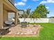 Backyard features a charming patio with a fire pit, a seating area, and lush green grass at 2118 Song Sparrow Ct, Ruskin, FL 33570