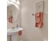 Cozy bathroom with pedestal sink, round mirror, and stylish decor at 2118 Song Sparrow Ct, Ruskin, FL 33570