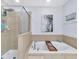 Modern bathroom showcases a soaking tub, shower, and a large picture at 2118 Song Sparrow Ct, Ruskin, FL 33570