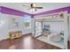 ' bedroom with a loft bed and purple accent wall, creating a fun space at 2118 Song Sparrow Ct, Ruskin, FL 33570