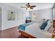 Cozy bedroom features a ceiling fan, light gray walls, and wood floors at 2118 Song Sparrow Ct, Ruskin, FL 33570