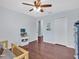 This is a light-filled bedroom that features wood-look flooring and a stylish fan at 2118 Song Sparrow Ct, Ruskin, FL 33570