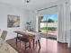 Dining area features a wooden table and bench seating with sliding glass doors opening to the backyard patio at 2118 Song Sparrow Ct, Ruskin, FL 33570