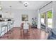 Bright dining area with a stylish wood table, barstool seating at the kitchen counter, and sliding glass doors at 2118 Song Sparrow Ct, Ruskin, FL 33570