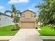 Well maintained two-story home with a two car garage and tropical landscaping at 2118 Song Sparrow Ct, Ruskin, FL 33570