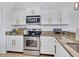 Modern kitchen showcasing stainless steel appliances, granite countertops, and white cabinetry at 2118 Song Sparrow Ct, Ruskin, FL 33570