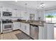 Well-appointed kitchen with stainless steel appliances, granite countertops, and ample white cabinetry at 2118 Song Sparrow Ct, Ruskin, FL 33570