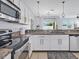 Bright kitchen with granite countertops, stainless steel appliances, and modern white cabinets at 2118 Song Sparrow Ct, Ruskin, FL 33570