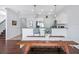 Open concept kitchen dining area with stainless steel appliances, pendant lighting, and a wooden dining table at 2118 Song Sparrow Ct, Ruskin, FL 33570