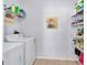 Functional laundry room featuring plenty of storage and a colorful art piece at 2118 Song Sparrow Ct, Ruskin, FL 33570