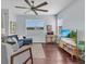 Cozy living room featuring modern furniture, a ceiling fan, and a flat screen TV, with view of the yard at 2118 Song Sparrow Ct, Ruskin, FL 33570