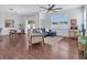 Bright living room with modern decor, hardwood floors, and a comfortable blue sectional sofa at 2118 Song Sparrow Ct, Ruskin, FL 33570