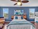 Bedroom with a wooden bed frame, blue accent wall, and a ceiling fan at 2118 Song Sparrow Ct, Ruskin, FL 33570