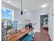 Office area with a large monitor, wood desk, and natural light at 2118 Song Sparrow Ct, Ruskin, FL 33570