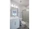 Modern bathroom with glass-enclosed shower, vanity, updated lighting, and fixtures at 2400 Ezzell Ct, Sarasota, FL 34237
