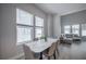 Bright dining room with modern table, chairs, and large windows letting in plenty of natural light at 2400 Ezzell Ct, Sarasota, FL 34237