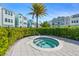 Community hot tub surrounded by lush greenery and well-maintained landscaping at 2400 Ezzell Ct, Sarasota, FL 34237