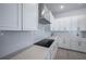 Stylish kitchen with white cabinetry, stainless steel range hood, and subway tile backsplash at 2400 Ezzell Ct, Sarasota, FL 34237