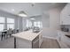 Modern kitchen features an island with a stainless steel sink, updated appliances, and pendant lighting at 2400 Ezzell Ct, Sarasota, FL 34237