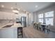 Bright kitchen with stainless steel appliances, white cabinetry, and adjacent dining area at 2400 Ezzell Ct, Sarasota, FL 34237