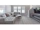Spacious living room with a comfortable sectional sofa, decorative pillows, and a modern fireplace at 2400 Ezzell Ct, Sarasota, FL 34237