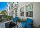 Comfortable patio space with two armchairs, a modern coffee table, and a view of the exterior and landscape at 2400 Ezzell Ct, Sarasota, FL 34237