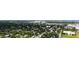 An aerial view showcases a neighborhood's lush landscaping and proximity to the coast at 2410 Prospect St, Sarasota, FL 34239