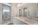 Bathroom with double sink vanity, modern fixtures, and a walk-in glass shower at 2410 Prospect St, Sarasota, FL 34239
