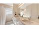 Bright bathroom features dual sinks, white cabinets, and a large mirror at 2410 Prospect St, Sarasota, FL 34239