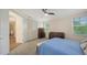 Bedroom with a queen size bed, furniture, carpet flooring, fan, and two windows at 2410 Prospect St, Sarasota, FL 34239