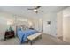 Bedroom with a queen size bed, furniture, carpet flooring, fan, and two windows at 2410 Prospect St, Sarasota, FL 34239