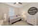 Well-lit bedroom with a window, dresser, and neutral carpet at 2410 Prospect St, Sarasota, FL 34239