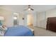Bedroom with a queen size bed, furniture, carpet flooring, fan, and two windows at 2410 Prospect St, Sarasota, FL 34239