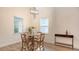 Cozy dining area with a round table, wood chairs and a stylish light fixture at 2410 Prospect St, Sarasota, FL 34239