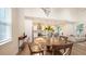 Bright dining area with wood table, hardwood floors, and modern kitchen in an open floor plan at 2410 Prospect St, Sarasota, FL 34239