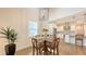 Charming dining room with wood floors, high ceilings, stylish light fixture, and a plant in a pot at 2410 Prospect St, Sarasota, FL 34239