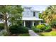 Charming two-story home features a well-manicured lawn and lush landscaping at 2410 Prospect St, Sarasota, FL 34239