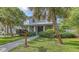 Charming two-story home features a well-manicured lawn and lush landscaping at 2410 Prospect St, Sarasota, FL 34239