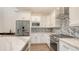 Modern kitchen with stainless appliances, granite countertops, backsplash and white cabinetry at 2410 Prospect St, Sarasota, FL 34239