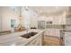 Bright and spacious kitchen with white cabinets, stainless appliances, and light hardwood floors at 2410 Prospect St, Sarasota, FL 34239