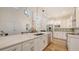 Bright kitchen with white cabinets, stainless appliances, center island, and an open floor plan at 2410 Prospect St, Sarasota, FL 34239