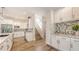Bright and modern kitchen with white cabinets, stainless appliances, and light hardwood floors at 2410 Prospect St, Sarasota, FL 34239