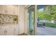 Bright kitchen leads to a patio with seating and lush landscaping at 2410 Prospect St, Sarasota, FL 34239