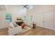 Comfortable living room with hardwood floors, bright windows, ceiling fan, and neutral decor at 2410 Prospect St, Sarasota, FL 34239