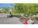 Outdoor patio area with an umbrella table, lush greenery, and privacy fencing for relaxing and entertaining at 2410 Prospect St, Sarasota, FL 34239