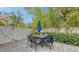 Outdoor patio area with an umbrella table, lush greenery, and privacy fencing for relaxing and entertaining at 2410 Prospect St, Sarasota, FL 34239
