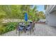 Outdoor patio area with umbrella table and additional seating offers relaxation and entertainment options at 2410 Prospect St, Sarasota, FL 34239