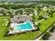 An aerial view of a community pool and clubhouse surrounded by lush landscaping at 2450 Dovesong Trace Dr, Ruskin, FL 33570